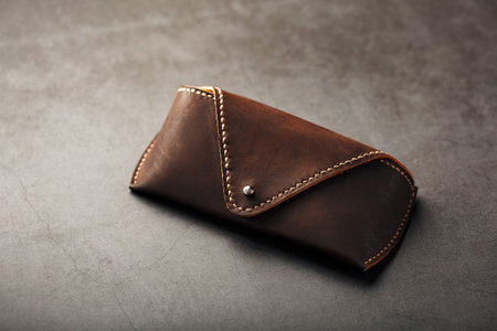 Handbag for glasses from genuine brown leather, handmade. Close-up