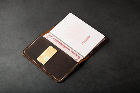 Open Passport Leather Cover with Gold Credit Card. Russian Federation, handwork close-up.