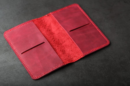 Open the red leather cover for your passport. Genuine leather, handmade. Close stitching, top view