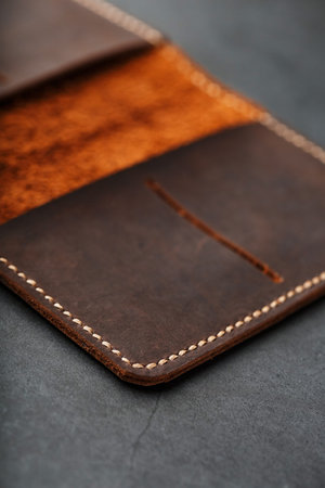 Open Dark Brown Leather Passport Cover. Genuine leather, handmade. Close up stitching, View from...