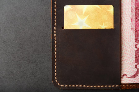 Open Passport Leather Cover with Gold Credit Card. Russian Federation, handwork close-up.