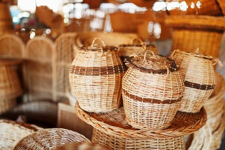 Handmade wicker baskets, items and souvenirs at the street craft market. Wicker baskets in a street marketの写真素材