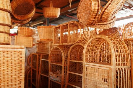 Handmade wicker furniture, products and souvenirs at the street craft market. Wicker baskets in a street marketの写真素材