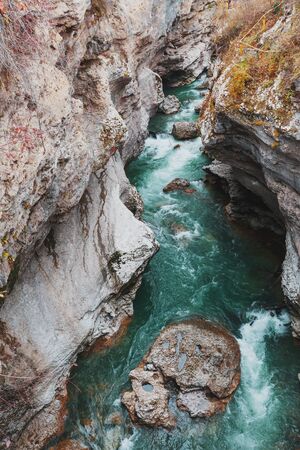 Gorge with a mountain river with a vibrant turquoise water between the rocks. Hadzhohskaya Tasnina Gorge Adygea Lago-Naki Kamennomostskiyの写真素材