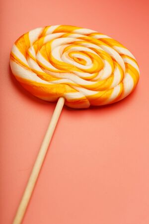 Colorful round Lollipop on pink background. Minimal concept with copy space. Confectionery, sweetsの写真素材