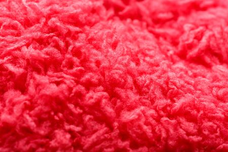 Wool yarn close-up colorful pink thread for needlework in macro. Background texture fabric for knitting needle. Full screen wool yarn.の写真素材