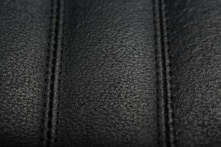 The texture of the black leather chairs. The seams close up. Elements of office furniture. close-up, full screenの写真素材