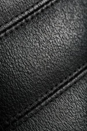 The texture of the black leather chairs. The seams close up. Elements of office furniture. close-up, full screenの写真素材
