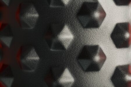 Black lumpy foam massage roller on red background. For the mechanical and reflex effects on tissues and organs. Close-up, texture, element in macroの写真素材