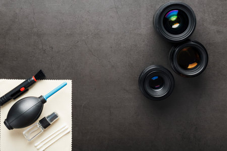 A set of tools to take care of your camera lenses on a dark background. Cleaning the camera. The...