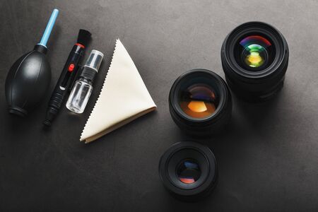 A set of tools to take care of your camera lenses on a dark background. Cleaning the camera. The view from the topの写真素材