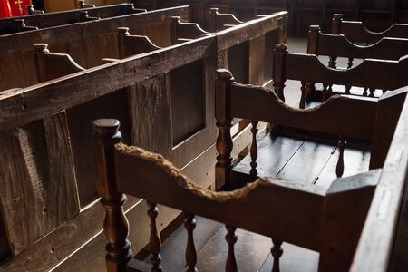 Rows of Church benches with sunlight close-up. Selective focus.の写真素材