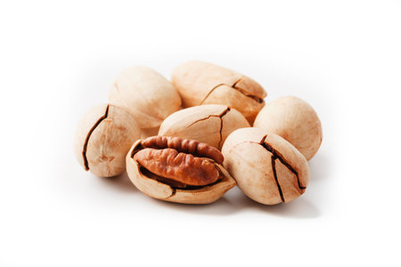 Pecan isolated on white background. Close-up, macro. A nut in a shell. Pecans are rich in various...