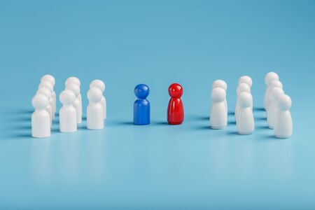 The conflict between two companies and a business, the rivalry of Leaders in blue and red leads a group of white employees to compete, Staff recruitment. A lot of employees are reaching for their boss. Personnel selection.の写真素材