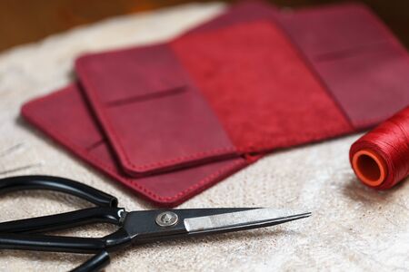 A leather craftsman works with leather. Sews leather goods. Making things handmade.の写真素材
