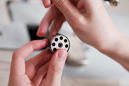 Replacing threads on a drum in a sewing machine. A leather craftsman produces leather goods on a...