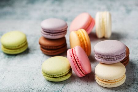 Multicolored macaroni cookies lie on a gray stone slab. Still-life of confectionery products.の素材 [FY310142033649]