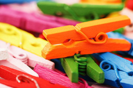 Colorful wooden clothespins close-up as a texture and background in full screen. Decorative...
