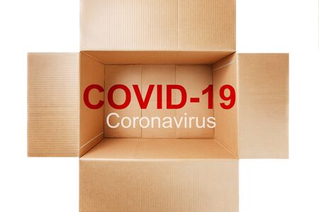 A coronavirus pandemic labeled COVID-19 inside a delivery service cardboard box. The concept of covid-19 infection through parcels and delivery services. Dangerous package.の写真素材