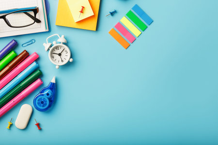 Office supplies lie on a blue background. To study in school. Rainbow color. Free space