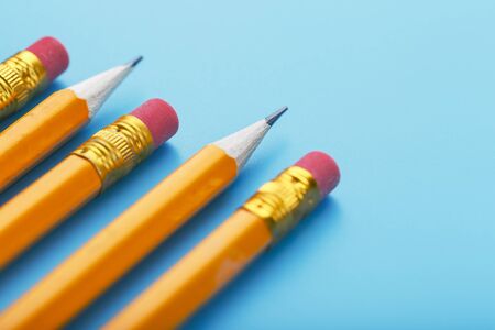 Orange pencils with an eraser on a blue background. Free spaceの写真素材