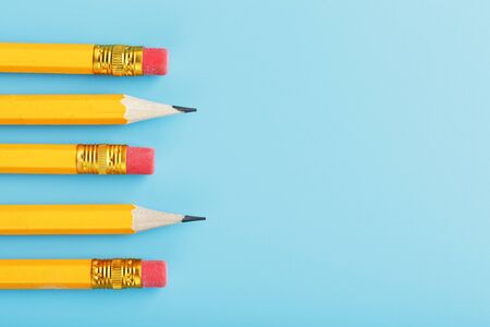 Orange pencils with an eraser on a blue background. Free spaceの写真素材