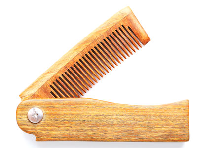 Wooden comb made of natural sandalwood for men on a white background. Care for men's hair and beard. Isolate. Barbershopの写真素材
