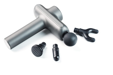 Manual electric body massager with attachments on a white background.の写真素材