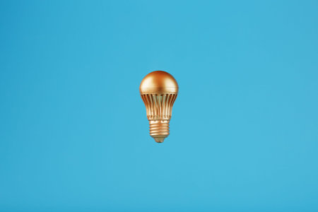 The light bulb is gold on a blue background. Concept of an idea with minimalism.