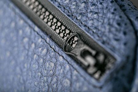 Zipper slider for a blue textured leather bag. Handmade. Close upの写真素材