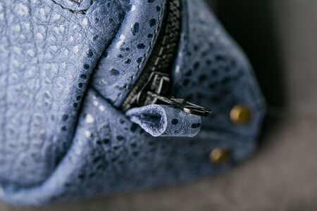 Zipper slider for a blue textured leather bag. Handmade. Close upの写真素材