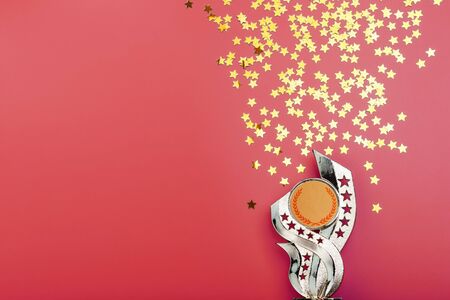 Superprize of gold with fireworks of stars on a red background. Reward for winning and achieving goals. Free spaceの写真素材