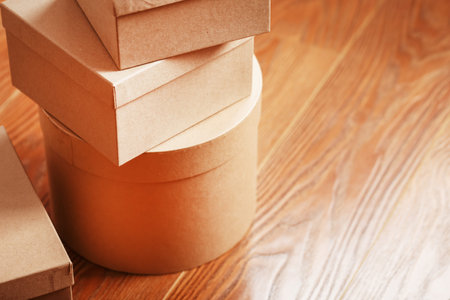 Postal cartons on the wooden floor. Free space for text and delivery ads.