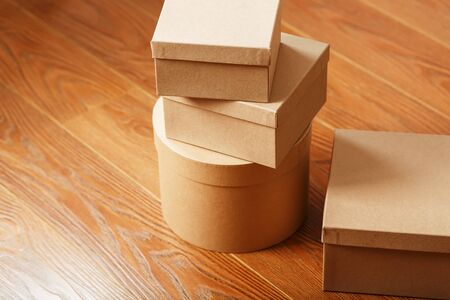Postal cartons on the wooden floor. Free space for text and delivery ads.の写真素材