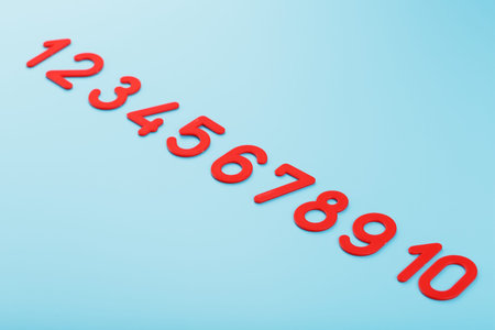 Red numbers on a blue background in a row from one to ten. Free space, top viewの写真素材