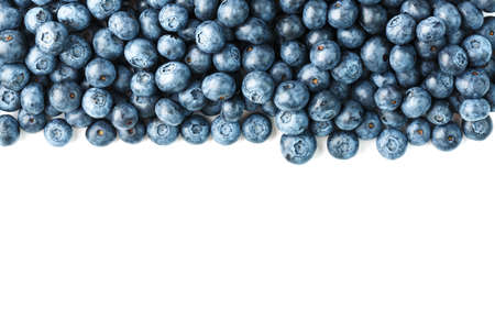 Tasty blueberries fruit are scattered on a white background. Isolate, free spaceの写真素材