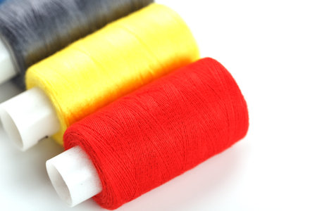 Colorful cotton craft sewing threads multicolored in a row isolated on a white background. Free...