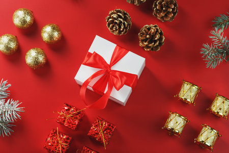 Christmas gift in the form of a white box with a red bow around Christmas decorations. New year's...