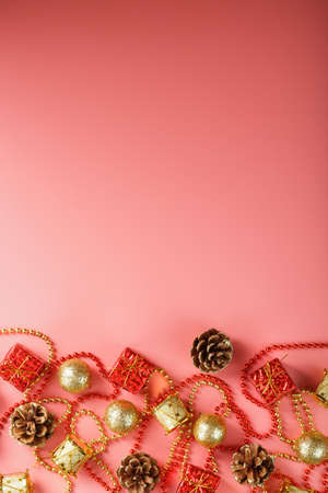 Christmas or new Year pink background with red and gold decorations for Christmas tree with free space. The view from the top. New year mood.の写真素材