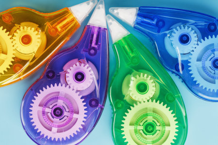 Multi-colored Stationery correction tapes on a blue background. Close-up