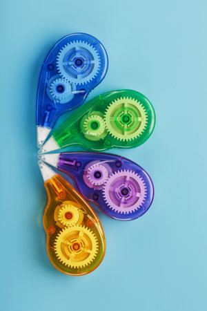 Stationery correction tapes are Multicolored on a blue background. Free space. The view from the...