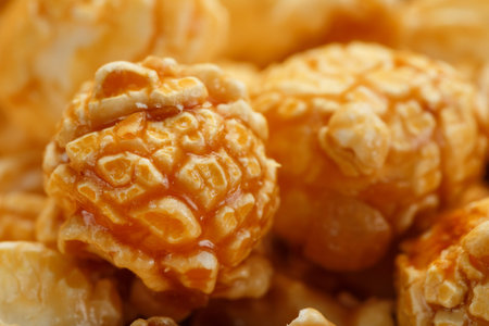 Caramel popcorn close-up as a background, full-screen texture. Admirable praise for watching movies, TV series, cartoons. Close-up, top viewの写真素材