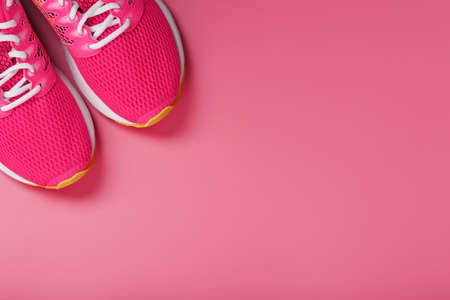 Sports pink sneakers on a pink background with free space. Top view, minimalistic conceptの写真素材