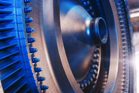 The rotor disk with the blades of a turbojet gas turbine engine with a blue glow. Elements, parts and mechanisms of turbines. Energy and mechanical engineering, square frameの写真素材