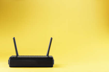 Router wireless LAN technology with devices based on IEEE 802.11 standards on a yellow background free space top view. Isolateの写真素材