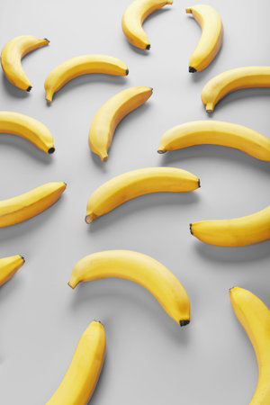 Bright pattern of yellow bananas on a gray background. View from above. Flat lay. Fruit patternsの写真素材