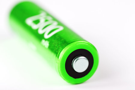 Green AA battery 2500 milliampere battery on a gray background, isolate. Finger batteryの写真素材