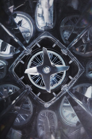 Inside the space of the blender glass and sharp stainless steel blades in the center. Inside view,...