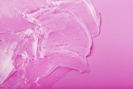 Transparent Gel on a pink background with free space. Antibacterial cosmetics
