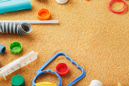 Discarded colorful plastic garbage from the ocean on the sand. Global environmental pollution. Free space, space for text in the frameの写真素材